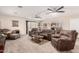 Open living room with neutral carpet, ceiling fans, and view into the kitchen and dining area at 76 N 133Rd St, Chandler, AZ 85225