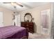 Bedroom with wooden furniture, carpeted floors, ceiling fan, and attached bath at 76 N 133Rd St, Chandler, AZ 85225