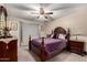 Bedroom with wooden furniture, ceiling fan, carpet, and light walls at 76 N 133Rd St, Chandler, AZ 85225