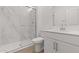 Modern bathroom with a glass shower, marble wall, white vanity, and stylish sink at 7987 W Griswold Rd, Peoria, AZ 85345