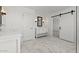 The bright bathroom features marble-look tile flooring, a dual vanity, and matte black fixtures at 7987 W Griswold Rd, Peoria, AZ 85345