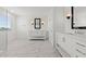This bright bathroom features marble-look tile flooring, a dual vanity, glass shower, and matte black fixtures at 7987 W Griswold Rd, Peoria, AZ 85345