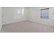 Cozy bedroom with neutral carpet, white walls, large windows, and neutral flooring at 7987 W Griswold Rd, Peoria, AZ 85345