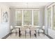 Beautiful dining room with bright windows, a hardwood table with six chairs at 7987 W Griswold Rd, Peoria, AZ 85345