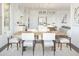 Elegant dining room with hardwood table and six chairs next to a kitchen at 7987 W Griswold Rd, Peoria, AZ 85345