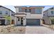Charming home with a brick paved driveway, manicured landscape, and covered front porch with stone pillars at 7987 W Griswold Rd, Peoria, AZ 85345