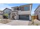 Inviting two-story home with a paver driveway and a charming facade featuring a mix of stone and siding at 7987 W Griswold Rd, Peoria, AZ 85345