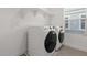 The laundry room features a side-by-side washer and dryer with extra shelving for storage at 7987 W Griswold Rd, Peoria, AZ 85345