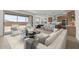 Open-concept living area with stylish furnishings, a modern kitchen, and seamless access to the outdoor space at 7987 W Griswold Rd, Peoria, AZ 85345