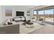 Bright living room with modern decor, stylish furniture, and sliding glass doors to the backyard at 7987 W Griswold Rd, Peoria, AZ 85345