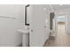 Bright powder room with pedestal sink, tile floors, and conveniently located near the entryway and stairs at 7987 W Griswold Rd, Peoria, AZ 85345
