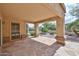 Enjoy outdoor living on this covered patio with stone flooring and decorative columns, seamlessly blending indoor and outdoor spaces at 8347 W Taro Ln, Peoria, AZ 85382