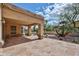 This covered patio boasts stone flooring and elegant columns, perfect for outdoor living and entertaining at 8347 W Taro Ln, Peoria, AZ 85382