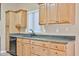 Practical kitchen layout with wood cabinetry, dark countertops, and stainless steel dishwasher at 8347 W Taro Ln, Peoria, AZ 85382