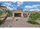 An outdoor patio with stone flooring and desert landscaping creates an inviting space for relaxation and entertaining at 8347 W Taro Ln, Peoria, AZ 85382