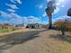 Large backyard featuring palm trees and a chain-link fence at 8350 W Monroe St, Peoria, AZ 85345