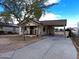 A view of this single-story home's exterior with driveway and simple landscaping, reflecting potential at 8350 W Monroe St, Peoria, AZ 85345