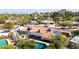 Overhead view of the backyard with pool, patio, terracotta roof, and solar panels, framed by mature trees and mountain views at 9234 N 33Rd Way, Phoenix, AZ 85028