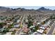 Scenic aerial view of a neighborhood nestled against a mountain range, showcasing lush landscaping and varied home styles at 9234 N 33Rd Way, Phoenix, AZ 85028