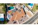 Aerial view of a private backyard pool, and a tiled roof with solar panels on a desert home at 9234 N 33Rd Way, Phoenix, AZ 85028