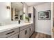 Bright bathroom featuring gray cabinets, modern fixtures, and a quartz countertop at 9234 N 33Rd Way, Phoenix, AZ 85028