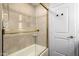 Enclosed shower featuring decorative tile and a glass door with gold trim at 9234 N 33Rd Way, Phoenix, AZ 85028