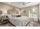 A neutral bedroom features a ceiling fan, decorative wall hangings, and natural light at 9234 N 33Rd Way, Phoenix, AZ 85028