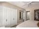 This bedroom has a ceiling fan, closet, and entry to another room at 9234 N 33Rd Way, Phoenix, AZ 85028