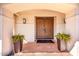 Covered entryway featuring a double door, tiled porch and desert landscape at 9234 N 33Rd Way, Phoenix, AZ 85028