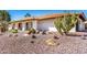 Single-story home featuring a barrel tile roof, desert landscape, and a covered front porch at 9234 N 33Rd Way, Phoenix, AZ 85028