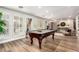 Spacious game room featuring a well-maintained pool table and shuttered windows at 9234 N 33Rd Way, Phoenix, AZ 85028