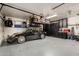 Well organized garage featuring a sleek black convertible and shelving for storage at 9234 N 33Rd Way, Phoenix, AZ 85028