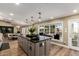 Kitchen island with seating, bright cabinets and views of dining area and outdoor space at 9234 N 33Rd Way, Phoenix, AZ 85028