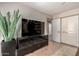 Comfortable living room featuring a black console and bright double doors at 9234 N 33Rd Way, Phoenix, AZ 85028