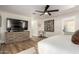 This main bedroom has wood-look floors, a large dresser, and a ceiling fan at 9234 N 33Rd Way, Phoenix, AZ 85028