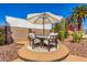 Charming outdoor patio features a table with umbrella and cushioned chairs on decorative tile at 9234 N 33Rd Way, Phoenix, AZ 85028