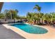 Backyard oasis features a sparkling pool with a rock waterfall and lush tropical landscaping at 9234 N 33Rd Way, Phoenix, AZ 85028