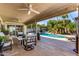 Back patio featuring seating, an outdoor pool, mature trees, and rock waterfall at 9234 N 33Rd Way, Phoenix, AZ 85028