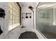 This tiled shower features glass block, a bench, and a shower head at 9234 N 33Rd Way, Phoenix, AZ 85028