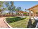 Lush backyard with a pergola-covered patio and green lawn, offering a serene outdoor retreat at 9413 W Pioneer St, Tolleson, AZ 85353