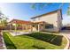 Beautifully landscaped backyard featuring a covered patio, pergola, and green lawn, perfect for enjoying the outdoors at 9413 W Pioneer St, Tolleson, AZ 85353