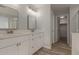 Bathroom features double sink vanity, quartz countertop, wood-style flooring and walk-in shower at 9413 W Pioneer St, Tolleson, AZ 85353