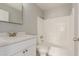 Bathroom featuring white cabinetry, quartz countertops, and shower-tub combo at 9413 W Pioneer St, Tolleson, AZ 85353