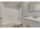 Bathroom featuring white cabinetry, quartz countertops, and shower-tub combo at 9413 W Pioneer St, Tolleson, AZ 85353