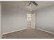 Neutral bedroom with open door, ceiling fan and plush carpet at 9413 W Pioneer St, Tolleson, AZ 85353