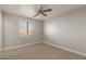 Bedroom features a carpet floors, ceiling fan, window with blinds and neutral paint at 9413 W Pioneer St, Tolleson, AZ 85353