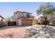 View of the two story home with low maintenance front yard and a two car garage at 9413 W Pioneer St, Tolleson, AZ 85353