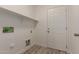 Laundry room with wood-look flooring, a shelf and hook-ups at 9413 W Pioneer St, Tolleson, AZ 85353