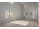 Bright living room featuring new laminate floors, high ceilings, and lots of natural light at 9413 W Pioneer St, Tolleson, AZ 85353