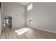 Bright living room featuring new laminate floors, high ceilings, and natural light at 9413 W Pioneer St, Tolleson, AZ 85353